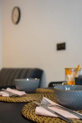 a table with two bowls and napkins on it at Accommodation for 4 people in Valencia