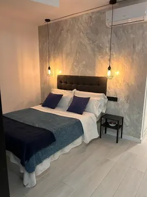 a bedroom with a large bed with blue pillows at Accommodation for 4 people in Valencia