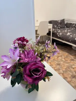 a bouquet of purple flowers in a vase on a table at Hogar Mediterráneo in Valencia