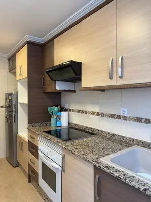 a kitchen with a sink and a counter top at Hogar Mediterráneo in Valencia