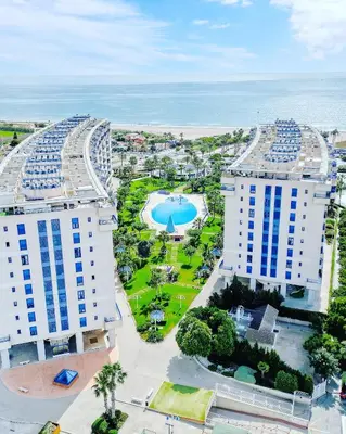 an aerial view of two tall buildings and a park at Complejo de playa in Valencia