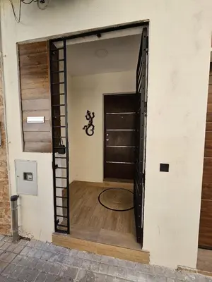 an open door to a garage with a motorcycle in it at Family Home Valencia in Aldaia