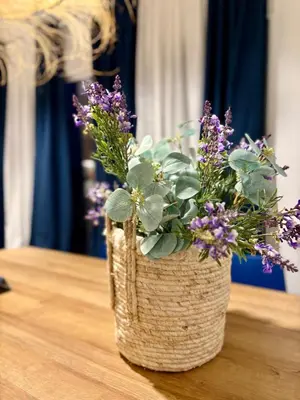 a vase filled with purple flowers sitting on a table at Family Home Valencia in Aldaia