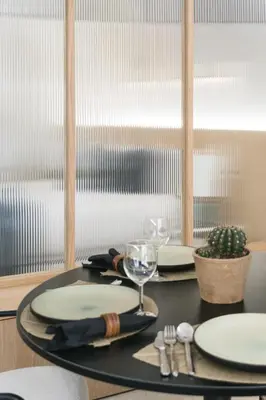 a table with two plates and a wine glass at FLORIT FLATS - Estudio de Diseño en el Corazón de Ruzafa in Valencia