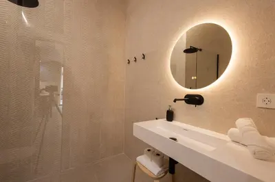 a bathroom with a sink and a mirror at FLORIT FLATS - Estudio de Diseño en el Corazón de Ruzafa in Valencia