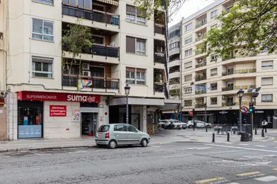 a small car parked in front of a building at FLORIT FLATS - Estudio de Diseño en el Corazón de Ruzafa in Valencia