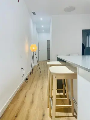 a kitchen with a table and two stools at Plus Ultra Ruzafa 6 in Valencia
