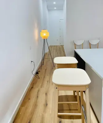 a room with two white chairs and a counter at Plus Ultra Ruzafa 6 in Valencia