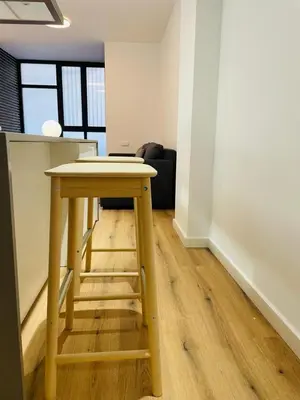 a wooden table in an empty room with a table at Plus Ultra Ruzafa 6 in Valencia