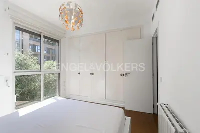 a white bedroom with a bed and a window at HomeSweetHome Valencia in Valencia