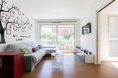 a living room with a couch and a tree on the wall at HomeSweetHome Valencia in Valencia