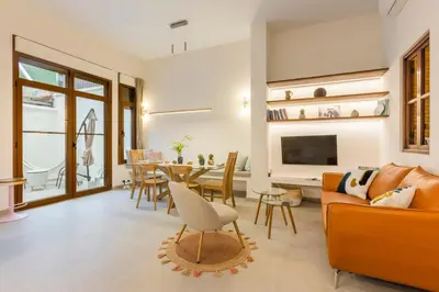a living room with a couch and a dining room at SeaFront Casa Valencia in Valencia