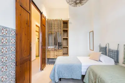 a bedroom with two beds and a door to a closet at SeaFront Casa Valencia in Valencia