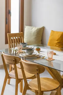 a dining room table with chairs and a table with plates at SeaFront Casa Valencia in Valencia