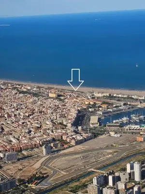 an aerial view of a city with a white arrow at SeaFront Casa Valencia in Valencia