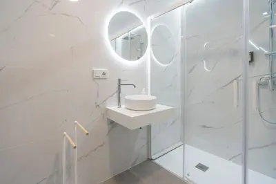 a white bathroom with a sink and a shower at VLC HOST - Oriente in Valencia