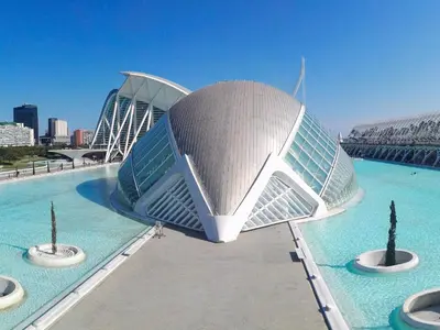 a building in the middle of a pool of water at Aqua Suites Ciudad de las Artes I in Valencia
