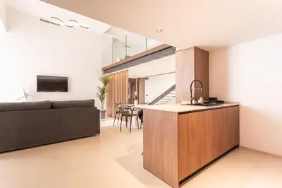 a kitchen and living room with a couch and a table at Aqua Suites Ciudad de las Artes I in Valencia