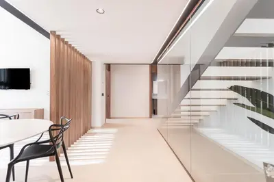 a staircase in a house with a table and chairs at Aqua Suites Ciudad de las Artes I in Valencia