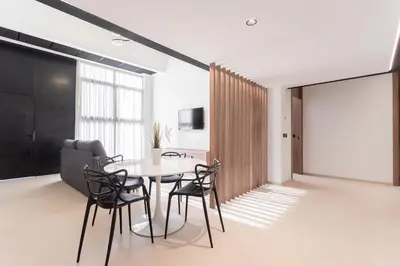 a dining room with a table and chairs at Aqua Suites Ciudad de las Artes I in Valencia