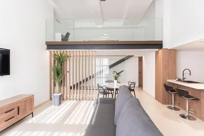 a living room with a couch and a table at Aqua Suites Ciudad de las Artes I in Valencia