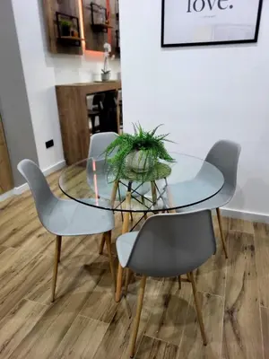 a glass dining table with four chairs and a plant on it at Charming Urban Stay in Valencia in Valencia