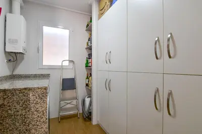 a kitchen with white cabinets and a ladder at Exclusive Villa in Catadau: Pool & Private Gardens in Catadau