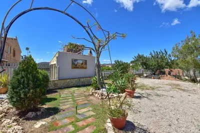 a garden with potted plants and an arbor at Exclusive Villa in Catadau: Pool & Private Gardens in Catadau