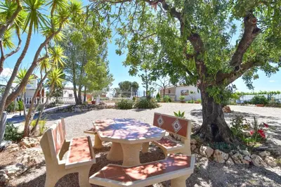 a picnic table and chairs under a tree at Exclusive Villa in Catadau: Pool & Private Gardens in Catadau