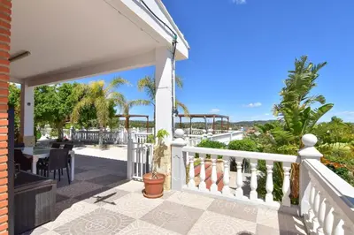 a balcony with a view of the ocean at Exclusive Villa in Catadau: Pool & Private Gardens in Catadau