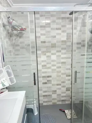 a shower with a glass door in a bathroom at Bahia Park Résidence in Cullera