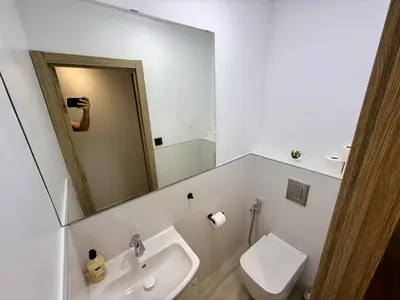a bathroom with a sink and a toilet and a mirror at Cómodo Apartamento cerca de la playa de San Antonio, dos baños in Cullera