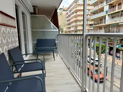 a balcony of a building with chairs on it at Cómodo Apartamento cerca de la playa de San Antonio, dos baños in Cullera