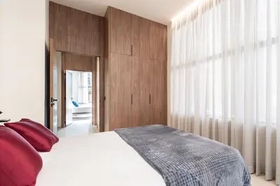 a bedroom with a large white bed with red pillows at Aqua Suites Ciudad de las Artes II in Valencia