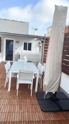 a white table and white chairs on a deck at Stylish and renovated house in Cullera