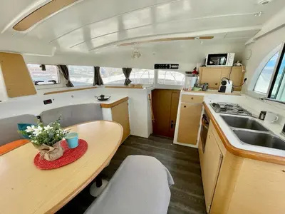 a kitchen with a wooden table and a sink at Barco para dormir sobre el Mar in Valencia