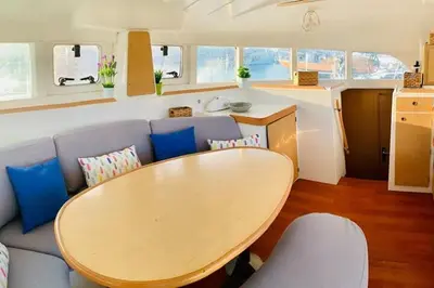 a living room with a wooden table and a couch at Barco para dormir sobre el Mar in Valencia
