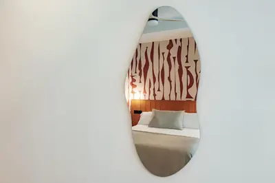 a room with a bed and a mirror at The Atelier Lofts in Valencia