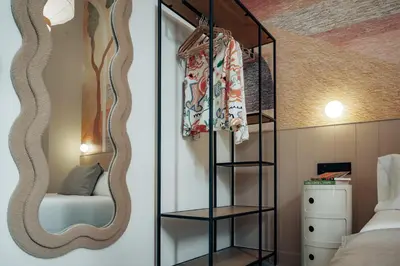 a bedroom with a mirror above a bed at The Atelier Lofts in Valencia