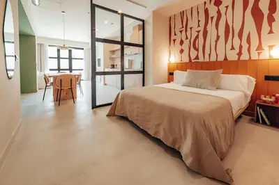 a bedroom with a large bed and a table at The Atelier Lofts in Valencia