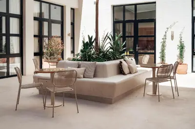 a living room with a couch and two tables and chairs at The Atelier Lofts in Valencia