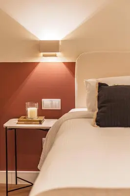 a bedroom with a bed and a table with a lamp at SariStays Valencia Luxe Touch in Valencia