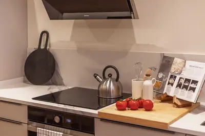 a kitchen with a counter with tomatoes on a cutting board at SariStays Valencia Luxe Touch in Valencia