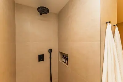 a shower in a bathroom with a shower curtain at SariStays Valencia Luxe Touch in Valencia