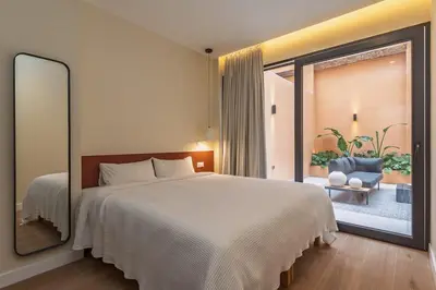 a bedroom with a large bed and a large window at SariStays Valencia Luxe Touch in Valencia
