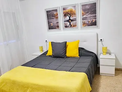 a living room with a white couch and a table at Apartamento playa Valencia in Mareny Barraquetas