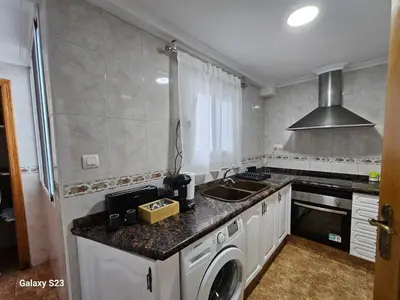 a bedroom with a bed and a couch at Apartamento playa Valencia in Mareny Barraquetas