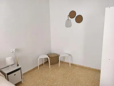 a bedroom with a bed with a yellow blanket at Apartamento playa Valencia in Mareny Barraquetas