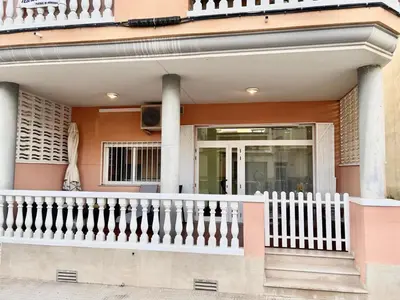 a house with a white railing and a porch at Planta baja en pleno centro de la playa in Moncófar