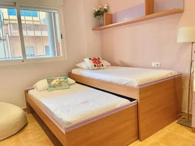 two bunk beds in a room with a window at Planta baja en pleno centro de la playa in Moncófar